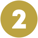 A circular gold medallion with the number “2” in white in the center.